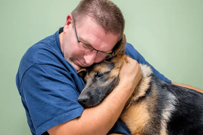 dog cuddling with owner