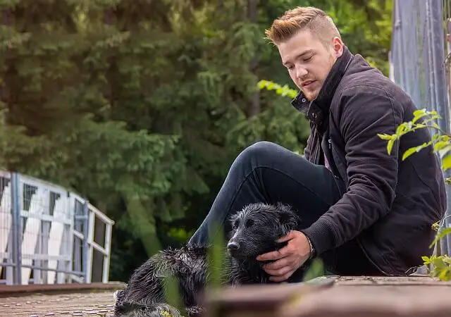 guy and a wet dog