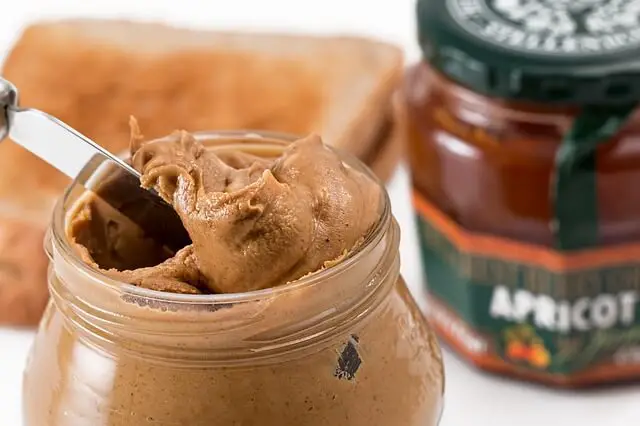 peanut butter in jar and knife